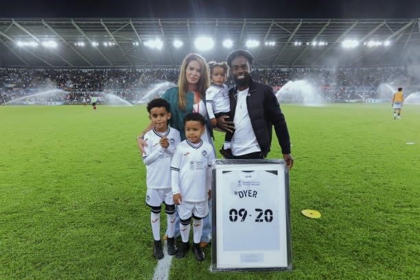 Former Swansea City player Nathan Dyer with his family pose for a picture during half time during the Sky Bet Championship match between Swansea City...