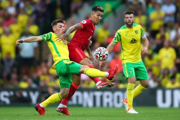 Roberto Firmino of Liverpool tangles with Billy Gilmour of Norwich City during the Premier League match between Norwich City and Liverpool at Carrow...