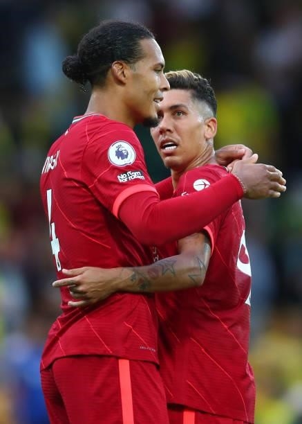 Virgil van Dijk of Liverpool embraces Roberto Firmino during the Premier League match between Norwich City and Liverpool at Carrow Road on August 14,...