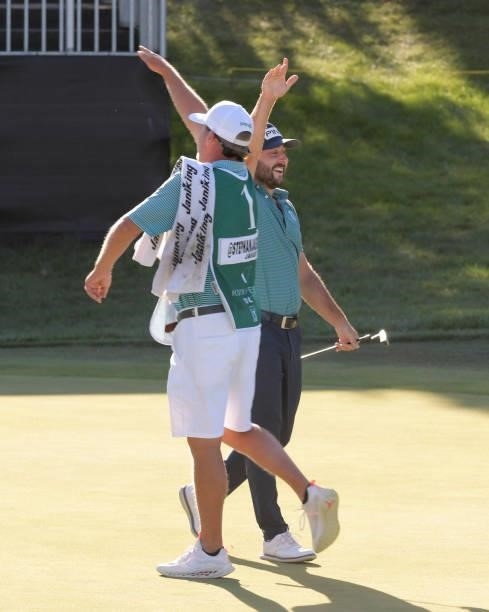 Stephan Jaeger celebrates his birdie putt with his caddie on the 18th green during the third round of the Korn Ferry Tours Pinnacle Bank Championship...