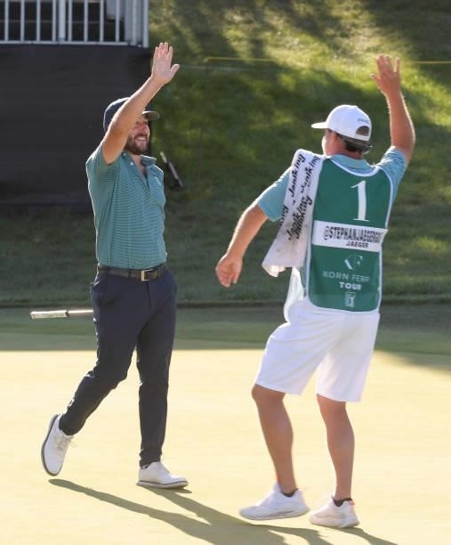 Stephan Jaeger celebrates his birdie putt with his caddie on the 18th green during the third round of the Korn Ferry Tours Pinnacle Bank Championship...