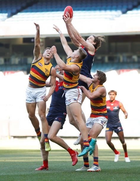Ben Brown of the Demons marks the ball against Tom Doedee, Nick Murray and Jordon Butts of the Crows during the 2021 AFL Round 22 match between the...
