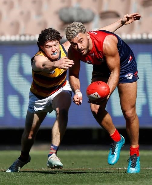 Harry Schoenberg of the Crows tackles Christian Salem of the Demons during the 2021 AFL Round 22 match between the Melbourne Demons and the Adelaide...