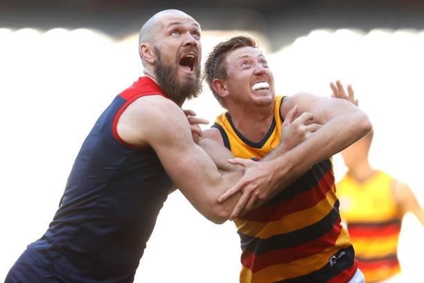 Kieran Strachan of the Crows and Max Gawn of the Demons compete in a ruck contest during the 2021 AFL Round 22 match between the Melbourne Demons and...