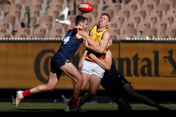 Tom Lynch of the Crows is tackled by Joel Smith of the Demons during the 2021 AFL Round 22 match between the Melbourne Demons and the Adelaide Crows...