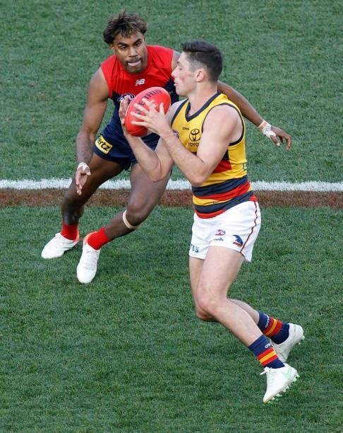 Chayce Jones of the Crows is tackled by Kysaiah Pickett of the Demons during the 2021 AFL Round 22 match between the Melbourne Demons and the...