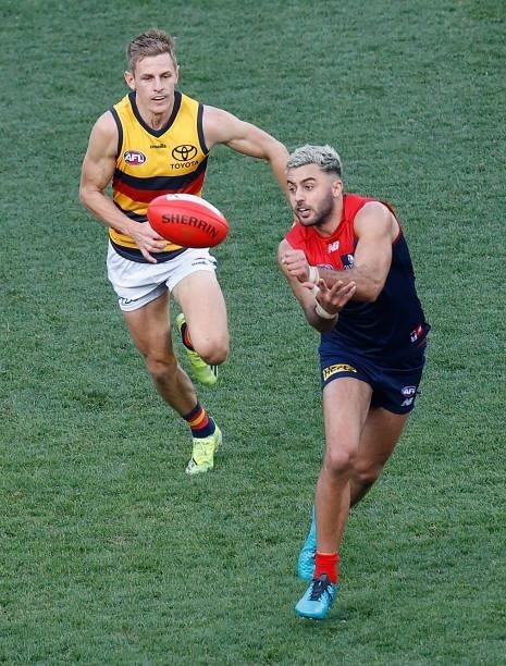 Christian Salem of the Demons handpasses the ball during the 2021 AFL Round 22 match between the Melbourne Demons and the Adelaide Crows at the...