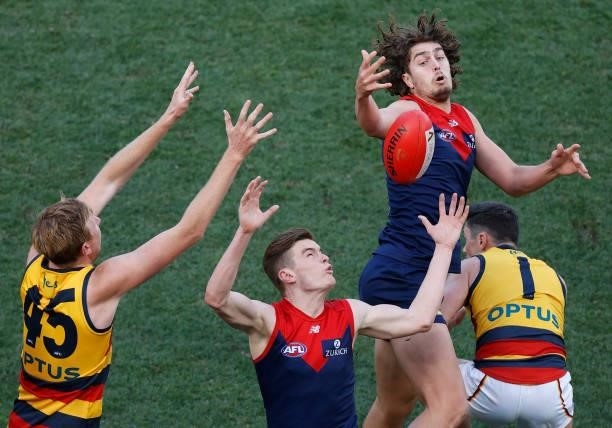 Kieran Strachan of the Crows, Bayley Fritsch of the Demons, Luke Jackson of the Demons and Chayce Jones of the Crows compete for the ball during the...