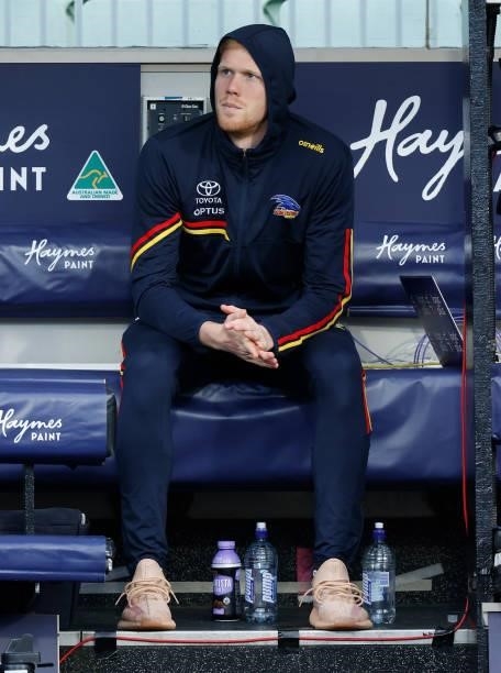 Elliott Himmelberg of the Crows looks on from the bench after being substituted from the match during the 2021 AFL Round 22 match between the...