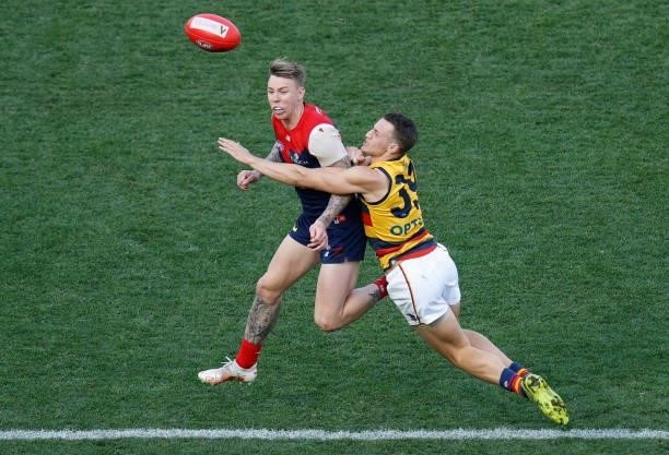 James Harmes of the Demons and Tom Doedee of the Crows in action during the 2021 AFL Round 22 match between the Melbourne Demons and the Adelaide...