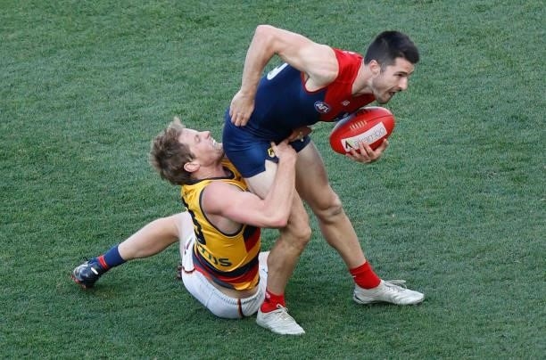 Alex Neal-Bullen of the Demons is tackled by Rory Sloane of the Crows during the 2021 AFL Round 22 match between the Melbourne Demons and the...