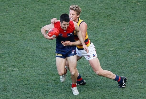 Alex Neal-Bullen of the Demons is tackled by Rory Sloane of the Crows during the 2021 AFL Round 22 match between the Melbourne Demons and the...