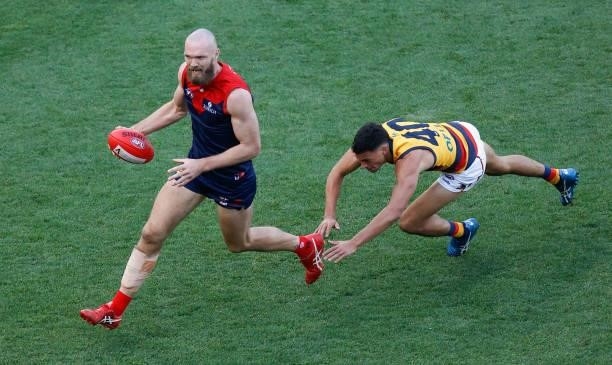 Max Gawn of the Demons is chased by Ben Davis of the Crows during the 2021 AFL Round 22 match between the Melbourne Demons and the Adelaide Crows at...