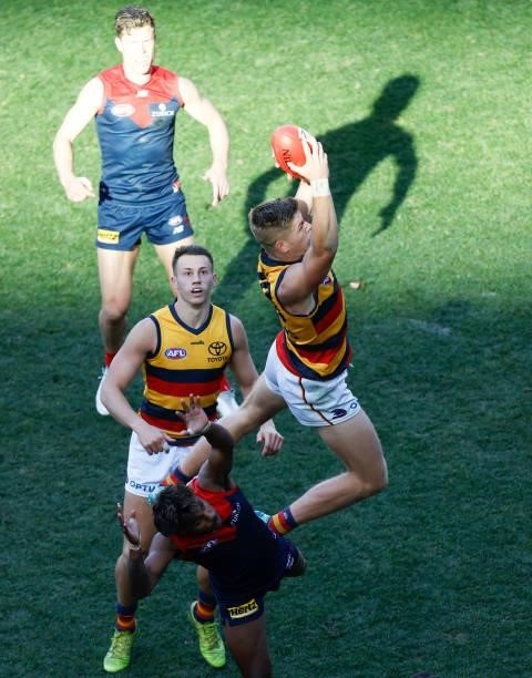 Nick Murray of the Crows takes a high mark against Kysaiah Pickett of the Demons during the 2021 AFL Round 22 match between the Melbourne Demons and...