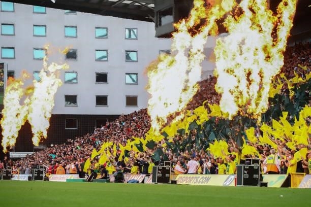 Pyrotechnic are seen as the fans welcome the team during the Premier League match between Norwich City and Liverpool at Carrow Road on August 14,...