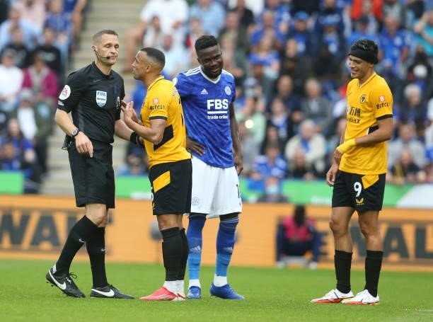 Referee Craig Pawson talks to Wolverhampton Wanderers' Fernando Marcal during the Premier League match between Leicester City and Wolverhampton...