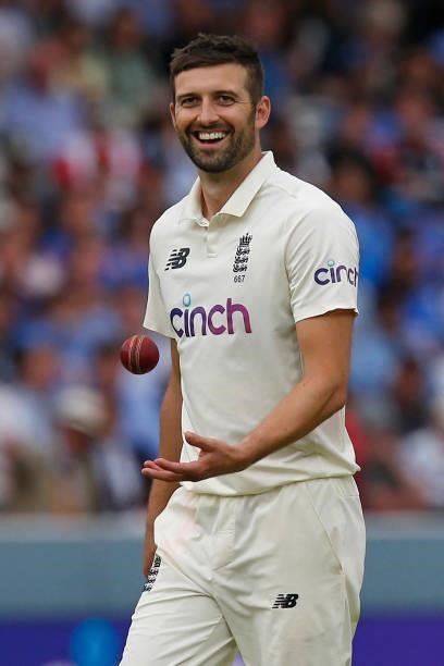 England's Mark Wood smiles as he prepares to bowl on the fourth day of the second cricket Test match between England and India at Lord's cricket...