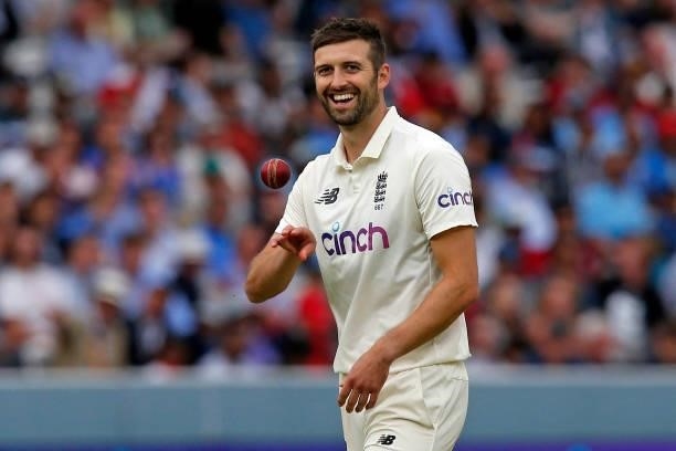 England's Mark Wood smiles as he prepares to bowl on the fourth day of the second cricket Test match between England and India at Lord's cricket...