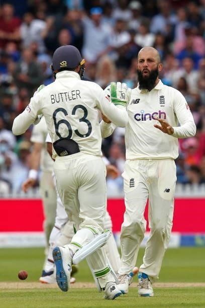 England's Moeen Ali and England's Jos Buttler celebrate after combining to take the wicket of India's Ajinkya Rahane for 61 runs on the fourth day of...