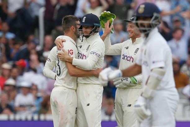 England's Mark Wood celebrates with teammates after taking the wicket of India's Cheteshwar Pujara on the fourth day of the second cricket Test match...