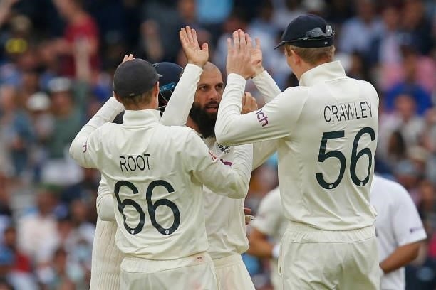 England's Moeen Ali celebrates with teammates after taking the wicket of India's Ajinkya Rahane for 61 runs on the fourth day of the second cricket...