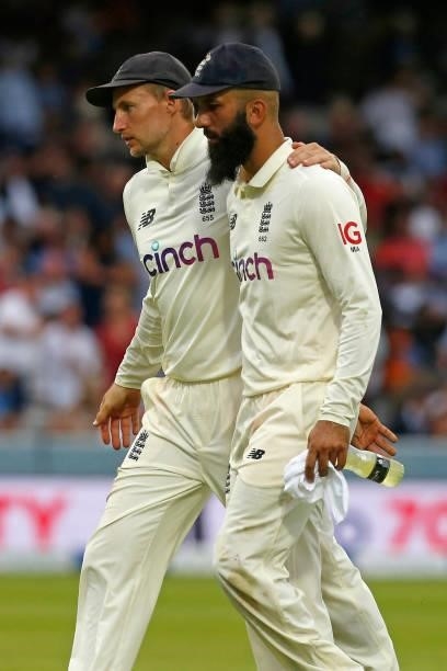 England's captain Joe Root walks off with England's Moeen Ali as bad light stops play on the fourth day of the second cricket Test match between...