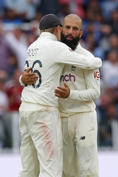 England's Moeen Ali celebrates with England's captain Joe Root after taking the wicket of India's Ravindra Jadeja for 3 runs on the fourth day of the...