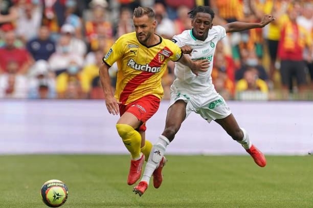 Jonathan Gradit of RC Lens is challenged by Yvan Neyou of AS St-Etienne during the Ligue 1 Uber Eats match between RC Lens and AS Saint Etienne at...