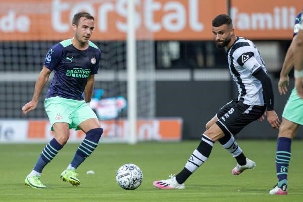 Mario Gotze of PSV Eindhoven and Rai Vloet of Heracles Almelo Battle for the ball during the Dutch Eredivisie match between Heracles Almelo and PSV...