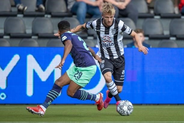 Phillipp Mwene of PSV Eindhoven and Kasper Lunding of Heracles Almelo Battle for the ball during the Dutch Eredivisie match between Heracles Almelo...