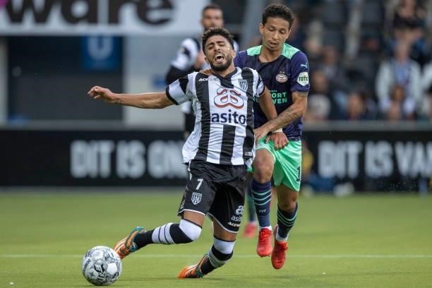 Bilal Basacikoglu of Heracles Almelo and Mauro Junior of PSV Eindhoven Battle for the ball during the Dutch Eredivisie match between Heracles Almelo...