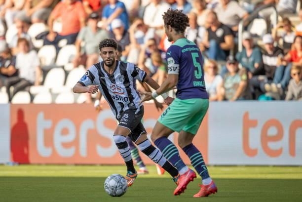 Bilal Basacikoglu of Heracles Almelo and Andre Ramalho of PSV Eindhoven Battle for the ball during the Dutch Eredivisie match between Heracles Almelo...