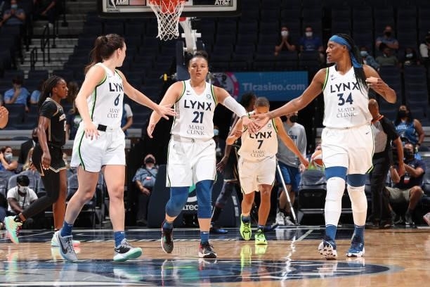 Kayla McBride hi-fives Bridget Carleton and Sylvia Fowles of the Minnesota Lynx during the game against the New York Liberty on August 15, 2021 at...