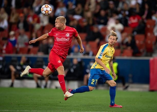 Rasmus Kristensen of Salzburg in action with Simon Hedlund of Broendby during the UEFA Champions League Play-Offs Leg One match between FC Red Bull...