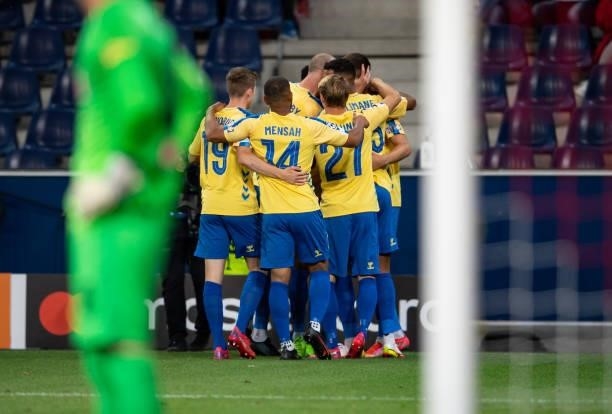 Mikael Uhre of Broendby celebrates his team's first goal with teammates during the UEFA Champions League Play-Offs Leg One match between FC Red Bull...