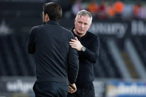Swansea City manager Russell Martin greets Stoke City manager Michael O'Neill after the final whistle during the Sky Bet Championship match between...