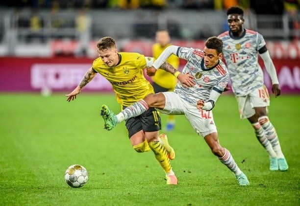 Marco Reus of Dortmund in action with Jamal Musiala of München during the Supercup 2021 match between FC Bayern München and Borussia Dortmund at...