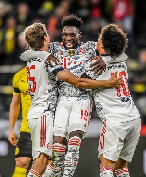 Thomas Mueller of München celebrates with Leroy Sane and Alphonso Davies after scoring his team's second goal during the Supercup 2021 match between...