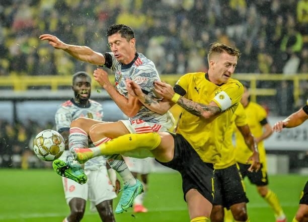 Marco Reus of Dortmund in action with Robert Lewandowski of München during the Supercup 2021 match between FC Bayern München and Borussia Dortmund at...