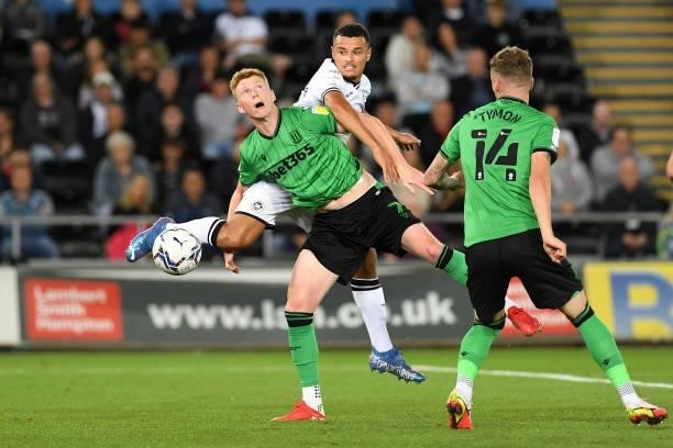 Joel Latibeaudiere of Swansea City vies for possession with Sam Clucas of Stoke City during the Sky Bet Championship match between Swansea City and...