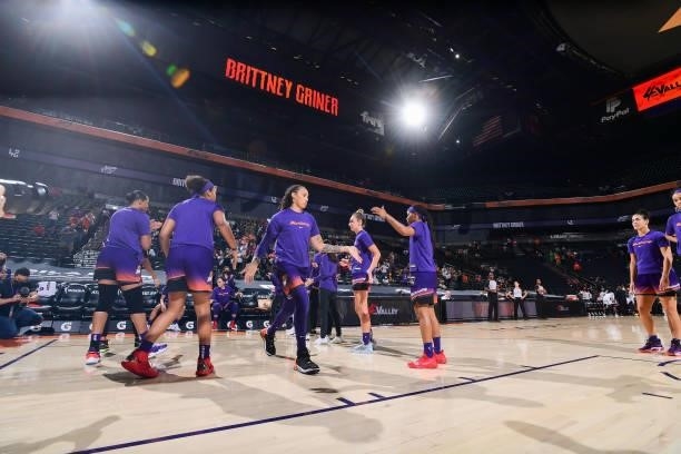 Brittney Griner of the Phoenix Mercury high fives her teammates before the game against the Indiana Fever on August 17, 2021 at Footprint Center in...