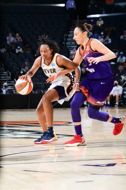 Kelsey Mitchell of the Indiana Fever handles the ball as Diana Taurasi of the Phoenix Mercury plays defense during the game on August 17, 2021 at...