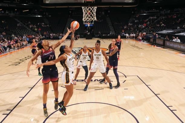 Brianna Turner of the Phoenix Mercury and Victoria Vivians of the Indiana Fever reach for the ball during the game on August 17, 2021 at Footprint...