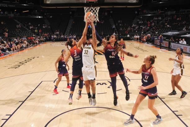 Diana Taurasi and Brittney Griner of the Phoenix Mercury and Emma Cannon of the Indiana Fever reach for the ball during the game on August 17, 2021...