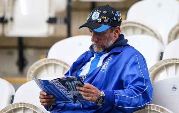 Huddersfield Town fan reads the programme before the Sky Bet Championship match between Huddersfield Town and Preston North End at Kirklees Stadium...