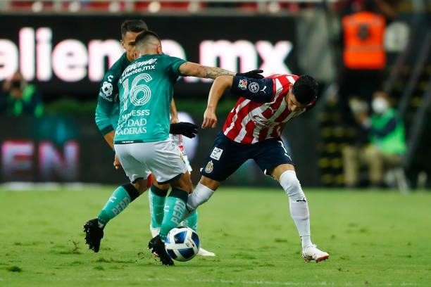 Carlos Antuna of Chivas fights for the ball with Jean Meneses of Leon during the 5th round match between Chivas and Leon as part of the Torneo Grita...