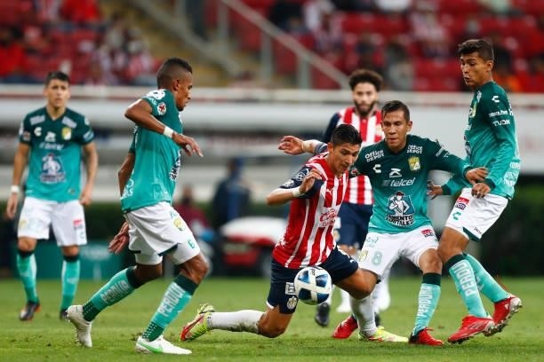 Angel Saldívar of Chivas fights for the ball with William Tesillo of Leon during the 5th round match between Chivas and Leon as part of the Torneo...