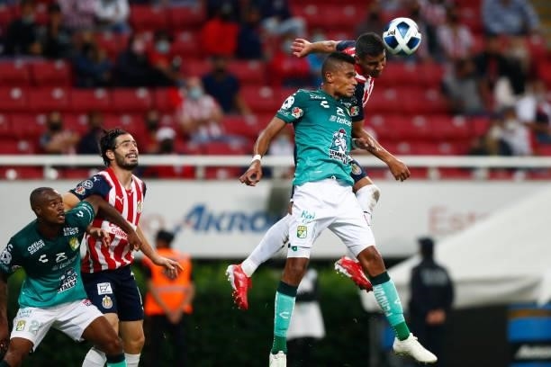 Gilberto Sepeulveda of Chivas jumps for the ball with William Tesillo of Leon during the 5th round match between Chivas and Leon as part of the...