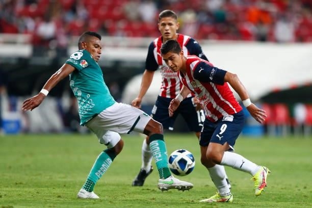 Angel Saldívar of Chivas fights for the ball with William Tesillo of Leon during the 5th round match between Chivas and Leon as part of the Torneo...