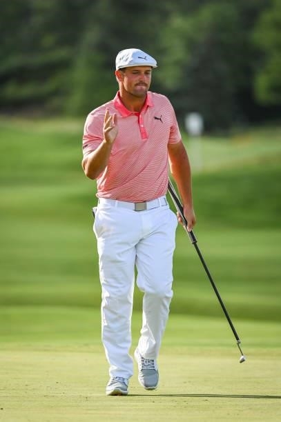 Bryson DeChambeau waves to fans after making a birdie putt on the 17th hole green during the first round of THE NORTHERN TRUST, the first event of...